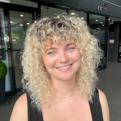 Curly Blonde Shag with Piece-y Bangs
