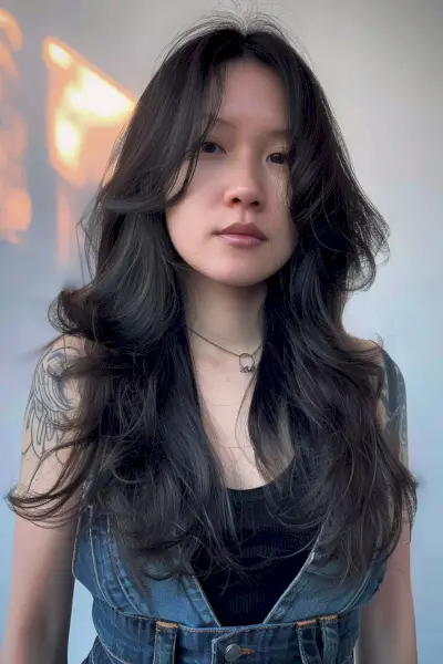 Long dark wolf haircut with face-framing waves