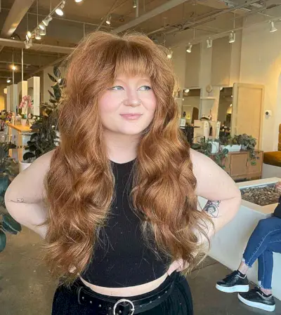 Wavy Long Layers with a Straight Fringe on Women with Fuller Face Shape