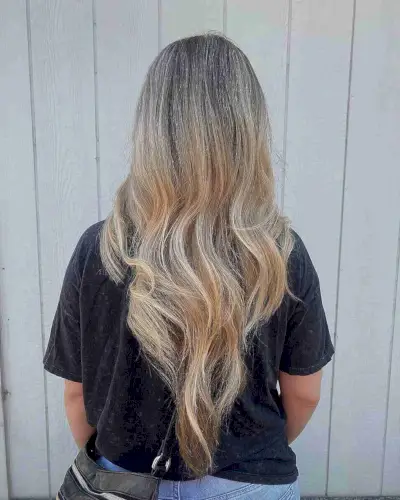 V-cut on waist-length hair with subtle waves