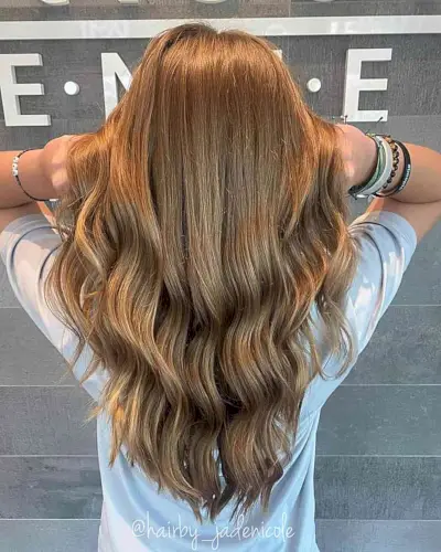 Golden Brown for a Waist-Length V Layered Haircut with Waves