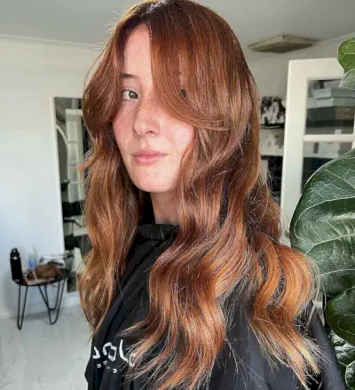Wavy Copper Hair with Long Curtain Bangs