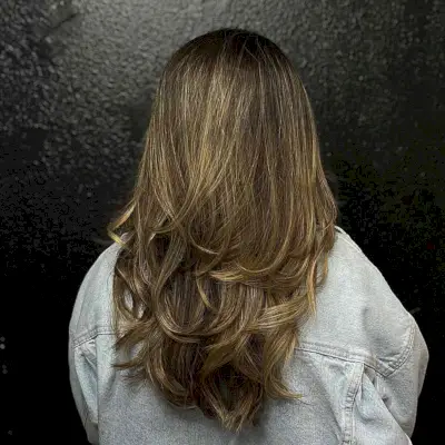 Dark-Rooted Golden Brown Long Hair with Feathered Piece-y Layers