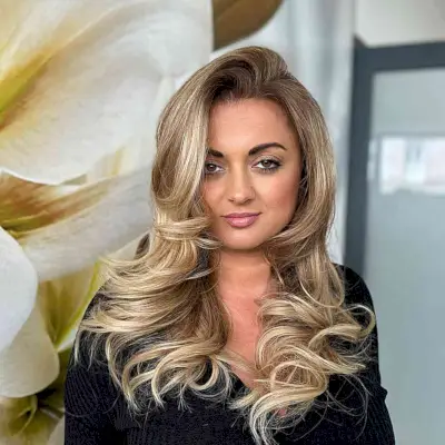 Long Dirty Blonde Balayage with a Side Part for Round Faces