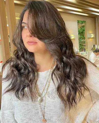 Loose Curls with Side Bangs for Round Faces