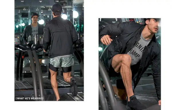 Niv Zinder má na sebe mikinu Reigning Champ gym crew, šortky Satisfy na dlhé vzdialenosti, Halo bomber bundu, šiltovku Herschel Supply Co. Guide Pack Albert a tenisky Y-3 Kohna.