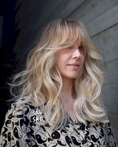 Medium-Length Thick Blowout Waves with Curtain Fringe and Blonde Balayage