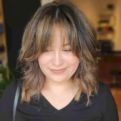Face-Framing Medium Cut with Curtain Bangs for a Round Face