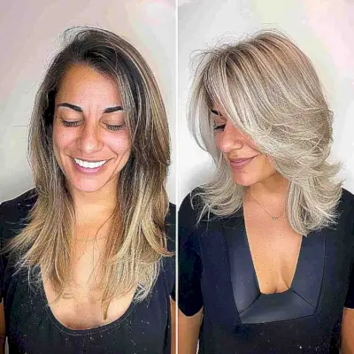 Shoulder-Length Blonde Side-Swept Layers and Bangs