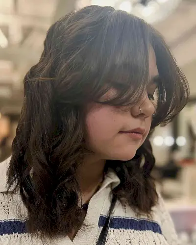 Long Curtain Bangs and Mid-Length Textured Waves for Ladies with Thick Locks