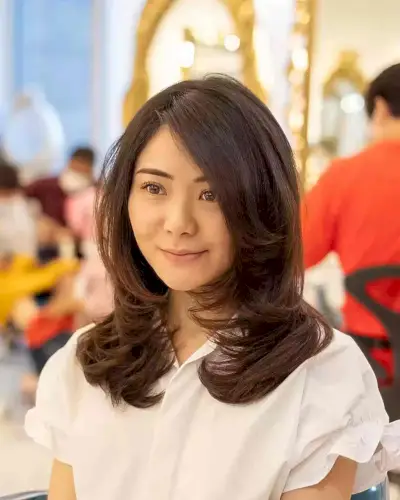 Thick Face-Framing Medium Cut with Swoopy Layers and Side Part Style