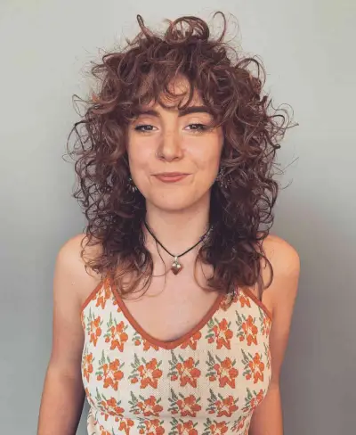 Mid-Length Shaggy Haircut on Curly Brunette Locks