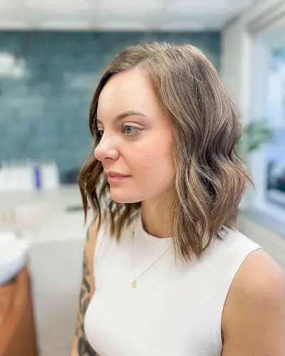 Messy shoulder length hair with a sandy brown ombre