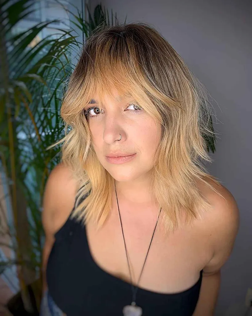 Taglio medio con strati mossi e frangia' title=