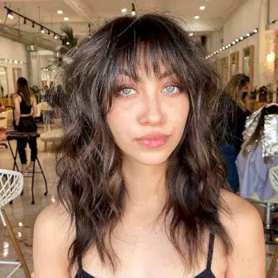 Medium Wavy Hair with Long Layers and Bangs