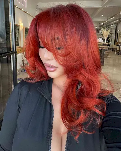 Medium-Length Pamela Anderson-Inspired Blowout with Face-Framing Layers