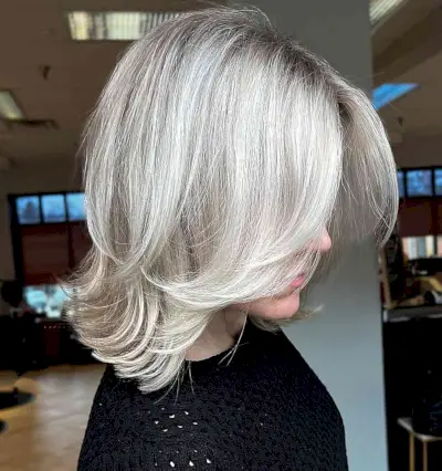 Platinum Feathered Layers on a Mid-Length Cut for Fine Hair