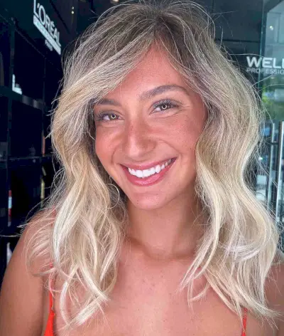 Light Layers and Side-Swept Bangs in Mid-Length Hairstyle for Thin Hair