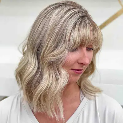 Mid-length wavy hair with bangs