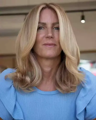 Face-Framing Long Curtain Bangs on Blonde Mid-Length Hair for a Low-Maintenance Style