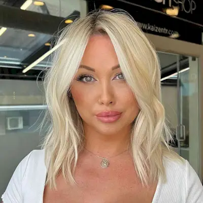 Baby Blonde Collarbone-Length Style for women with a middle part and choppy ends