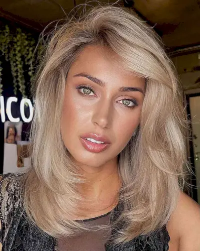 Medium Blonde Layers with a Swoop Bang 