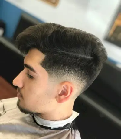 Low skin fade with long hair on top