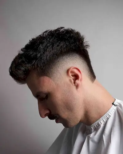 High Fade with a Long, Messy Top for Guys with thick hair