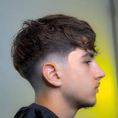 Tousled Wavy Hair with Low Tapered Burst Fade on Gents