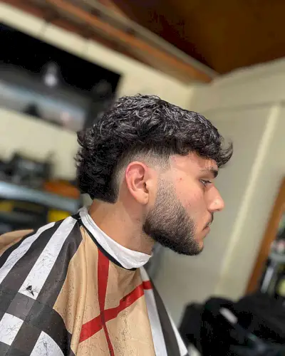 Textured Low Burst Fade Haircut with Beard Line-Up for Men