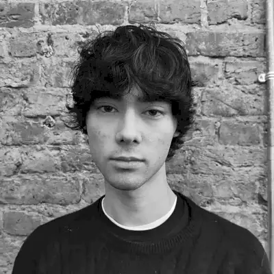 Modern Winged Haircut with Eye-Length Bangs for Men