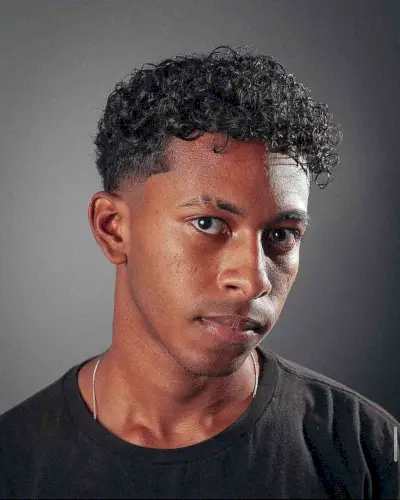 Asymmetrical Curly Fringe and Taper Fade for Guys