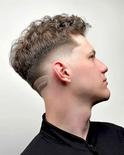Handsome Drop Fade Cut with Designs and Textured Bangs for Guys with wavy hair