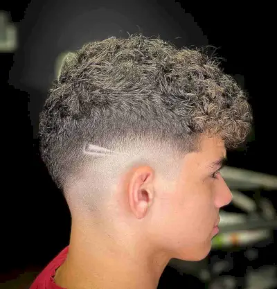 Messy Drop Fade Wavy Top with a Shaved Design for Guys