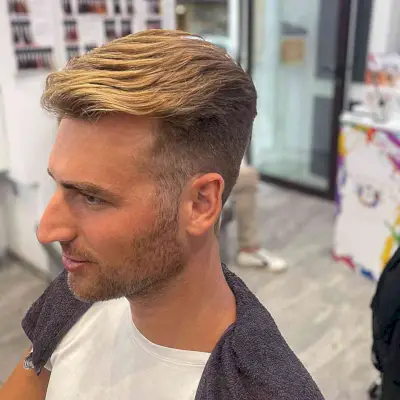 Slicked Back Faux Hawk Style with Blonde Highlights on Young Men