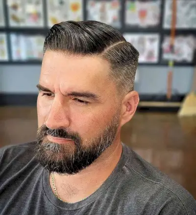 Slicked Back Combover with a Beard Fade for Men