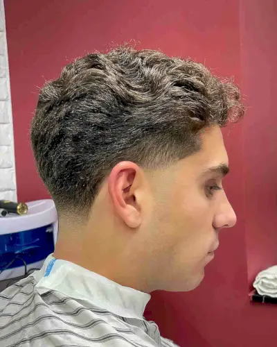 Low Taper Fade and Brushed Back Wavy Hair