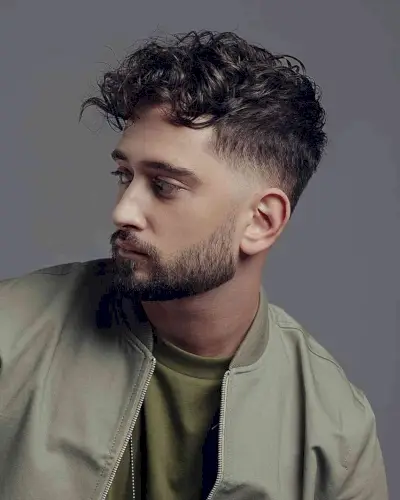 Messy curly hair and taper fade for guys