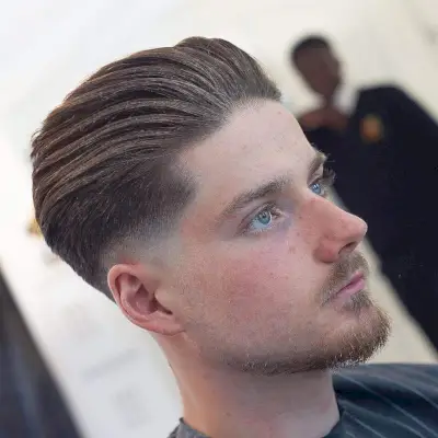 slicked back pomp with skin fade