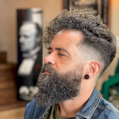 Side Part + Low Fade with a Long Curly Top for Men with Thick Hair
