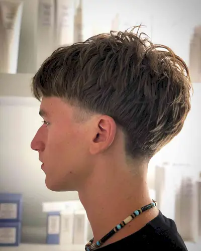 Voluminous Scruffy Edgar Bowl Cut on Guys with Thicker Hair
