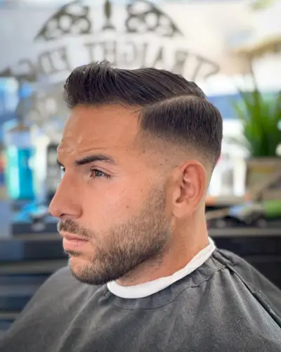 Ivy league haircut with hard part for men