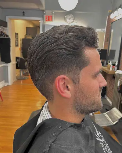 Subtle Wavy Slick Back with Low Taper Fade on Guys with Straight Hair