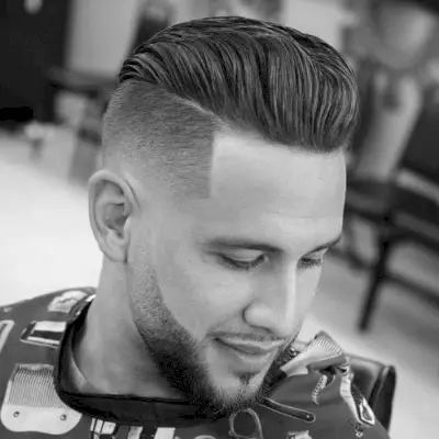 An low fade with a pompadour undercut