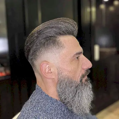 Straight Brushed-Back Pomp with a Skin Fade and Long Beard