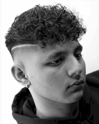 Disconnected Skin Bald Fade with a Curly Top
