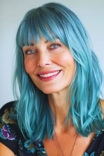 40代以上の女性のためのティーブルーフリンジのミディアムヘアスタイル。