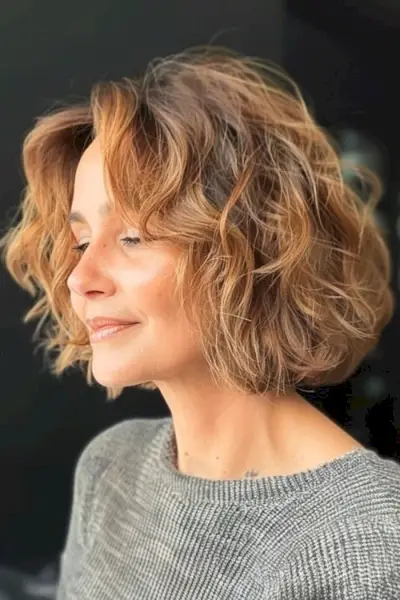 Peinado corto bob ondulado para mujeres mayores de 50 años con cabello fino.