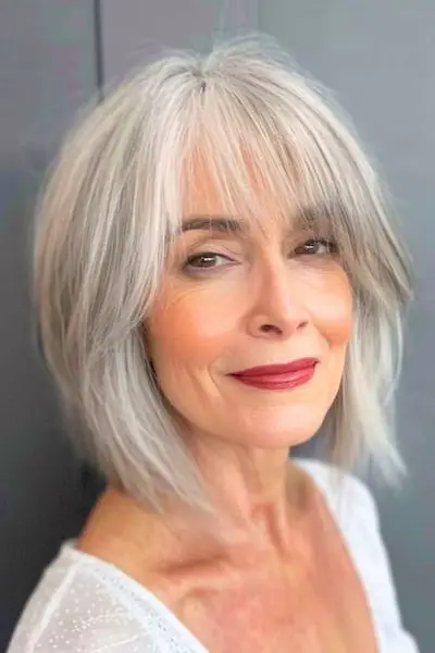 Wispy Silver Bob mit Pony-Frisur für Frauen über 60.
