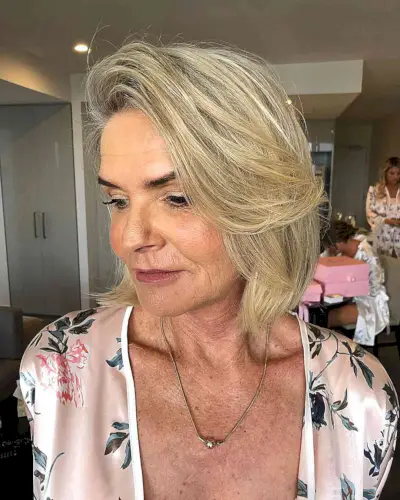 Neck-Length Blonde Lob with a Deep Side Part for Fine-Haired Women in their 50s